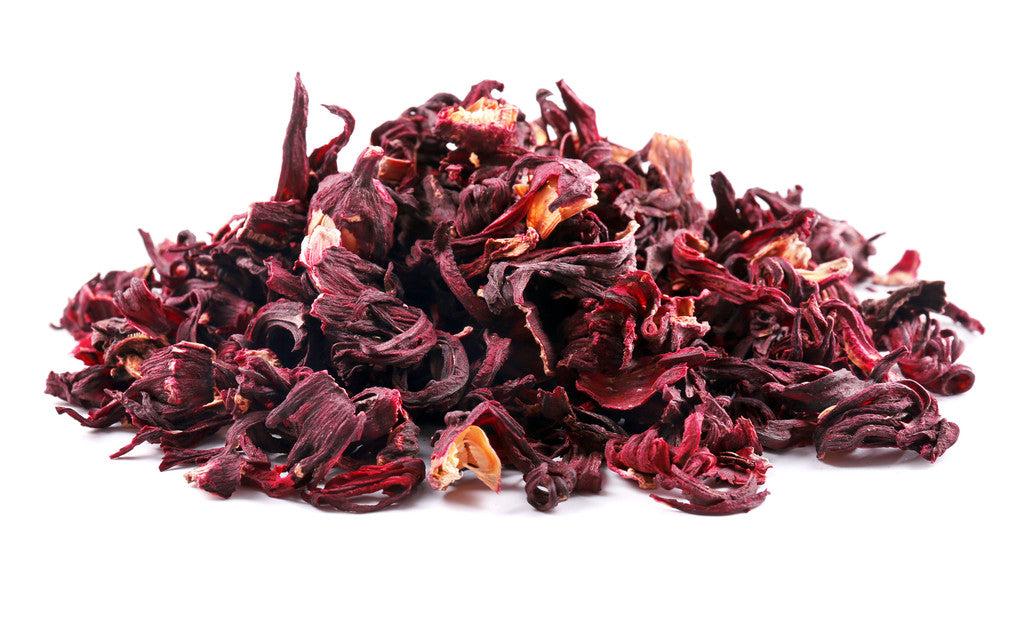 Dried Hibiscus Flowers for Tea Close-up of dried hibiscus flowers used to brew naturally caffeine-free hibiscus herbal tea with its deep ruby-red color and tart flavor.